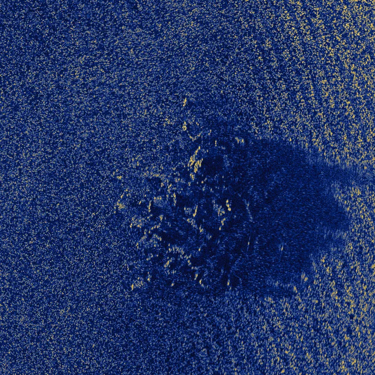 A rock outcrop and its acoustic shadow on rippled sand, simulated at 200 scatterers per square metre