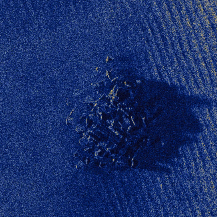 A rock outcrop and its acoustic shadow on rippled sand, simulated at 2,000 scatterers per square metre