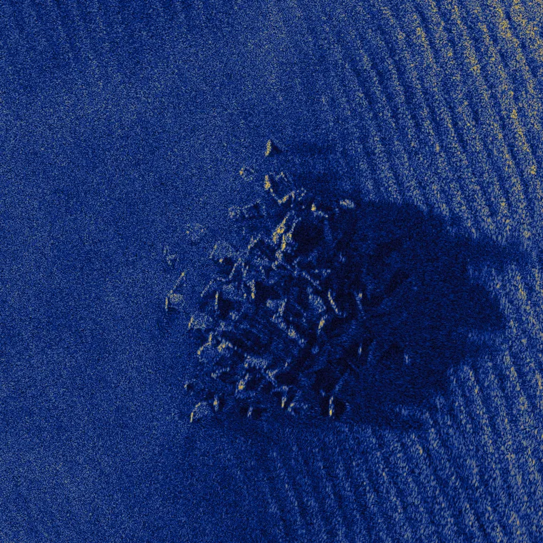 A rock outcrop and its acoustic shadow on rippled sand, simulated at 20,000 scatterers per square metre