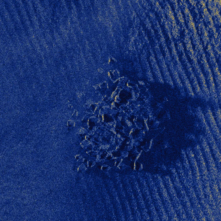 A rock outcrop and its acoustic shadow on rippled sand, simulated at 40,000 scatterers per square metre
