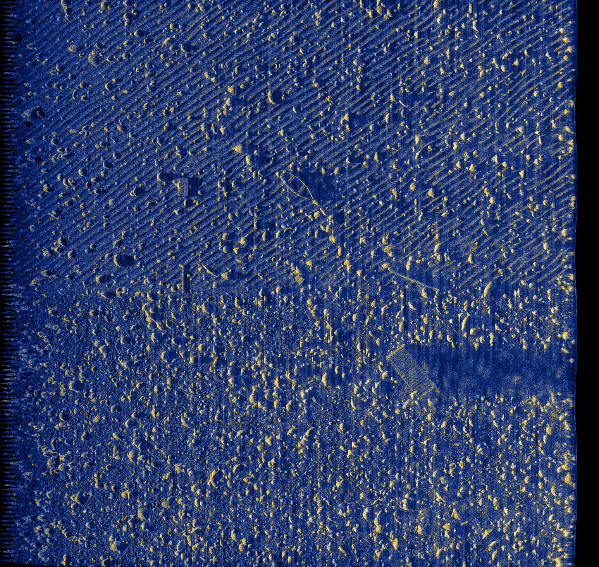Rocky seafloor with isolated target and ripple texture
