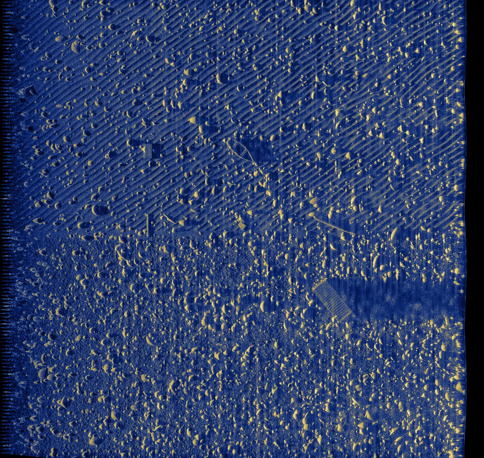 Rocky seafloor with isolated target and ripple texture