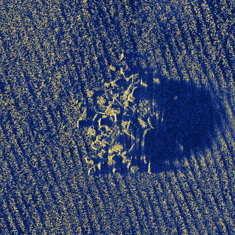 A rock outcrop and its acoustic shadow on rippled sand, simulated at 200 scatterers per square meter