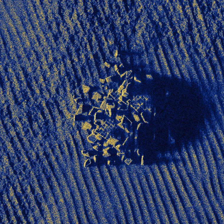 A rock outcrop and its acoustic shadow on rippled sand, simulated at 2,000 scatterers per square meter