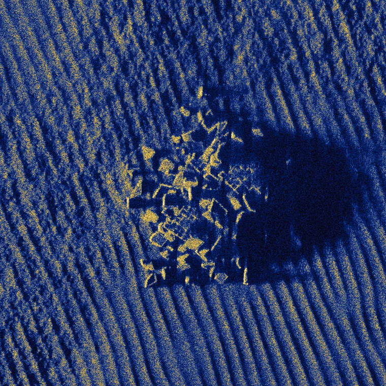 A rock outcrop and its acoustic shadow on rippled sand, simulated at 20,000 scatterers per square meter