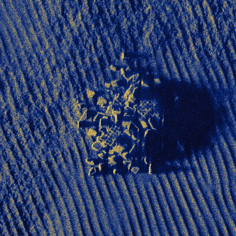A rock outcrop and its acoustic shadow on rippled sand, simulated at 40,000 scatterers per square meter